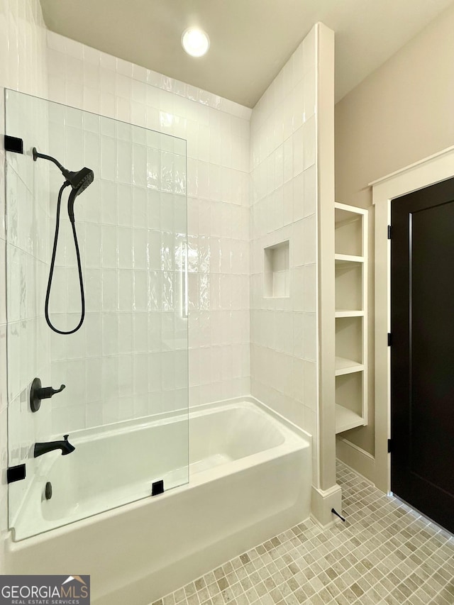 bathroom featuring tile patterned flooring and bathtub / shower combination