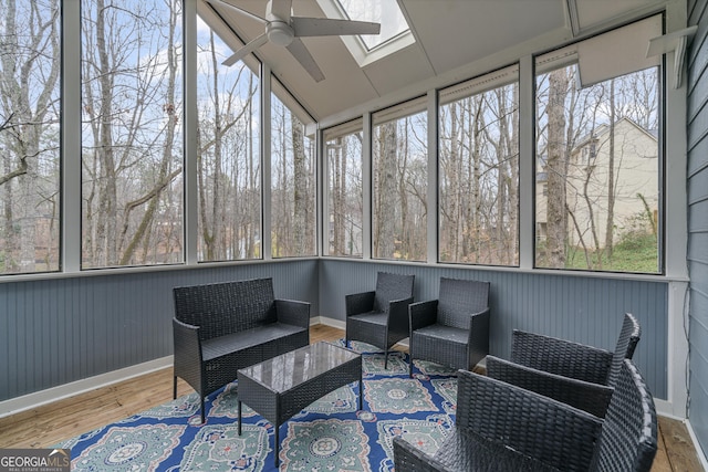 sunroom with vaulted ceiling with skylight and a ceiling fan