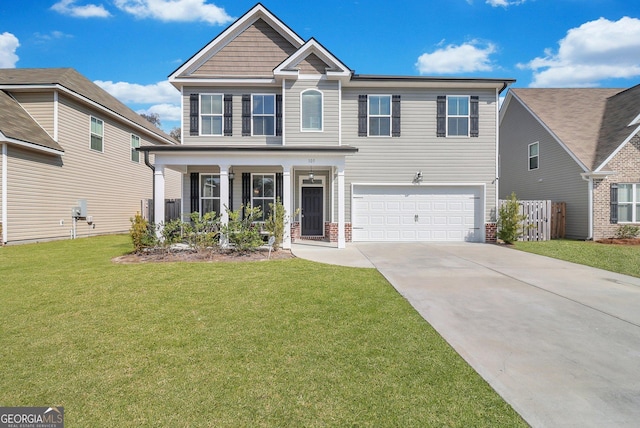 view of front of property featuring a garage, a front yard, and covered porch