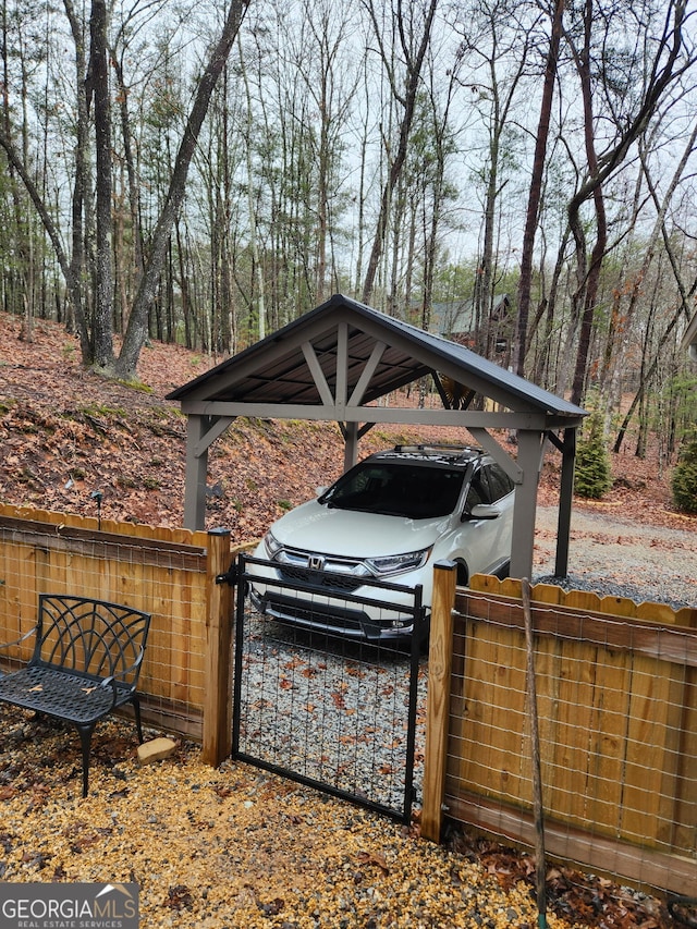 view of yard featuring a detached carport and fence