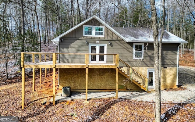 back of house featuring stairs, board and batten siding, and a wooden deck