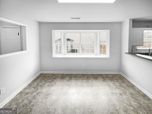 unfurnished dining area with plenty of natural light