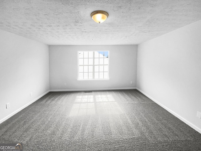 spare room with carpet and a textured ceiling