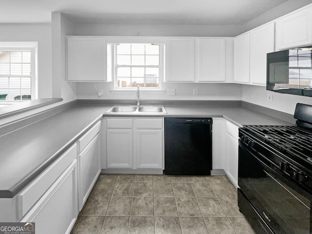 kitchen featuring white cabinetry, plenty of natural light, sink, and black appliances