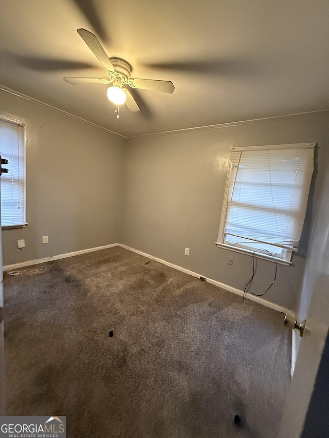 carpeted empty room featuring ceiling fan