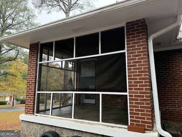 view of property exterior featuring a sunroom