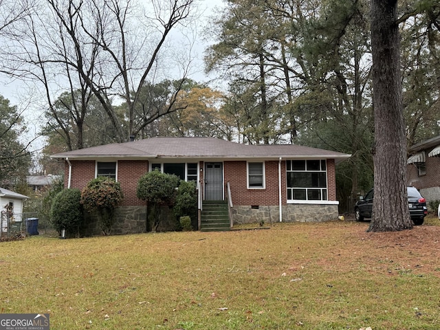 view of front of property featuring a sunroom and a front lawn