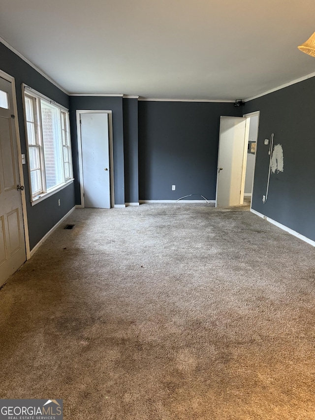 interior space with ornamental molding and carpet floors