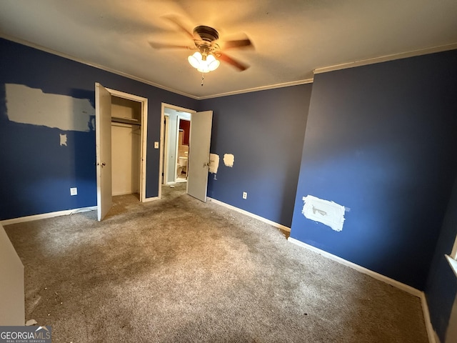 unfurnished bedroom featuring crown molding, carpet floors, ceiling fan, and a closet