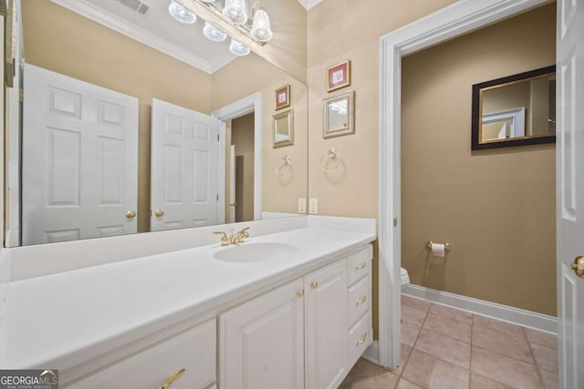 bathroom with vanity, tile patterned flooring, ornamental molding, and toilet