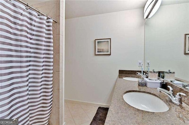 bathroom with walk in shower, vanity, and tile patterned flooring