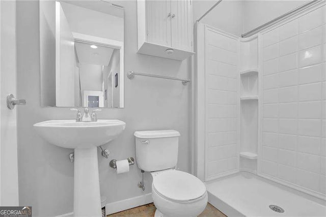 bathroom with a shower and toilet