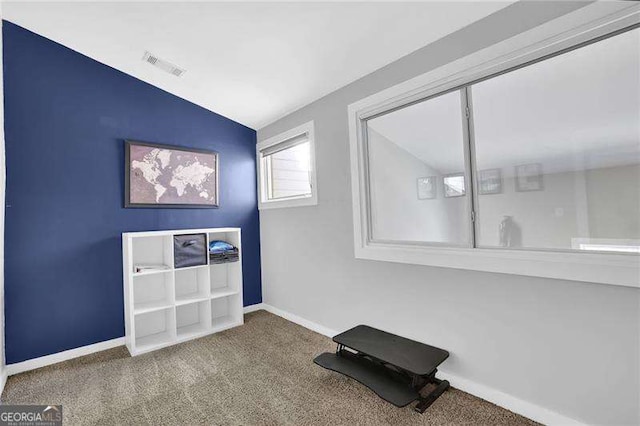 interior space featuring lofted ceiling and carpet floors