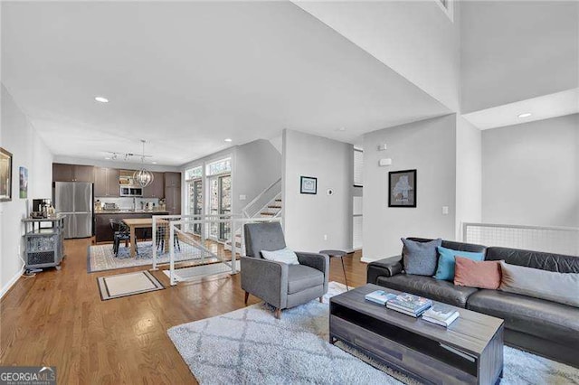 living room featuring an inviting chandelier and light wood-type flooring