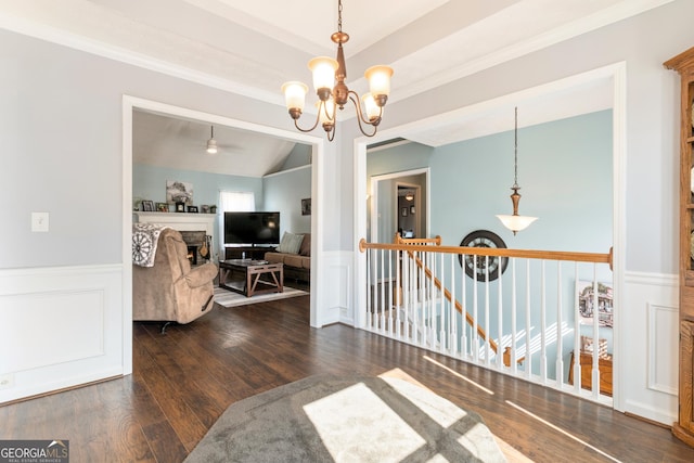 interior space featuring dark hardwood / wood-style flooring, vaulted ceiling, and a notable chandelier