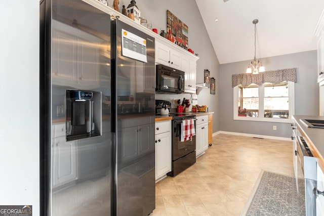 kitchen with high vaulted ceiling, decorative light fixtures, white cabinetry, a notable chandelier, and black appliances