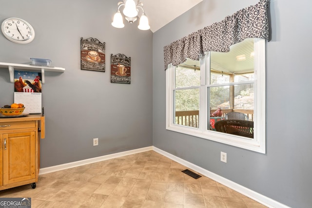 dining room featuring lofted ceiling and a chandelier