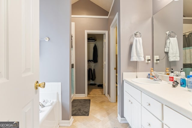 bathroom with vanity, lofted ceiling, and plus walk in shower