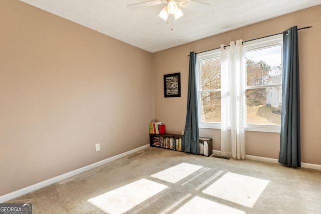 carpeted empty room with ceiling fan