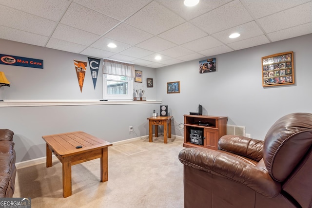 living room with carpet and a drop ceiling