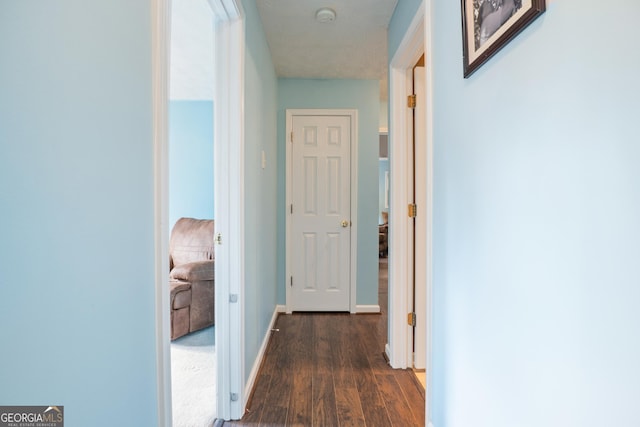 hall with dark hardwood / wood-style flooring