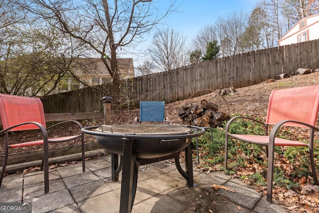 view of patio / terrace with an outdoor fire pit