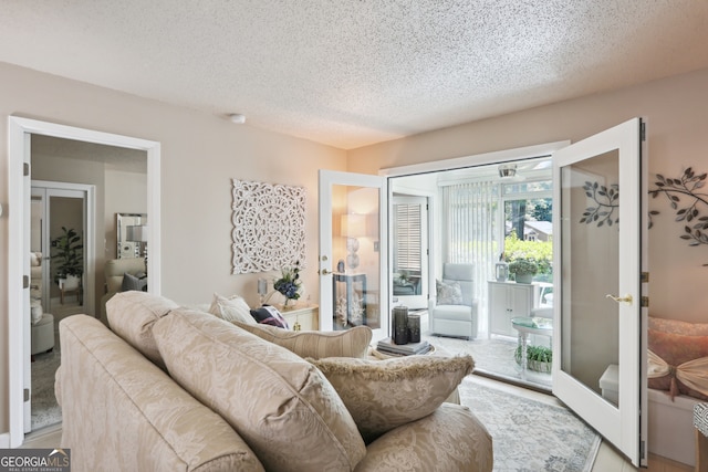 living room featuring french doors and a textured ceiling