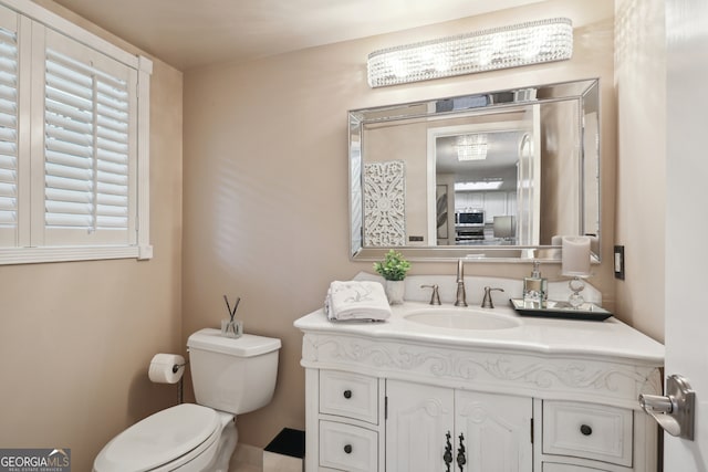 bathroom with vanity and toilet