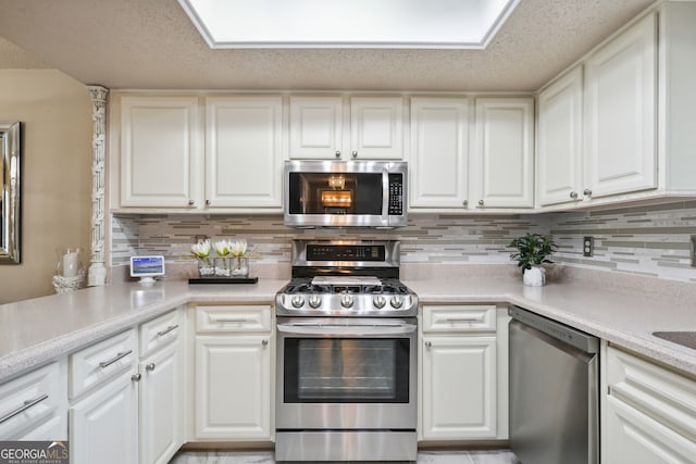 kitchen featuring white cabinets and appliances with stainless steel finishes