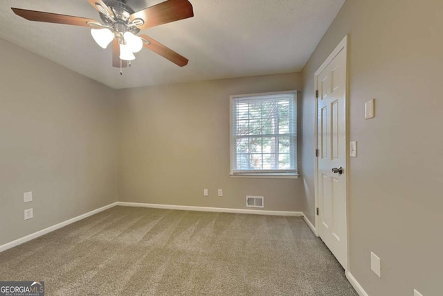 empty room featuring ceiling fan and carpet flooring