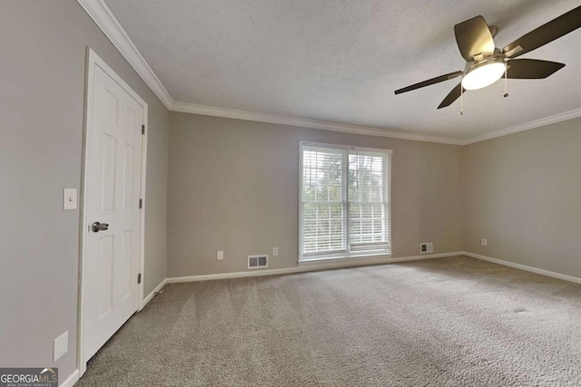 carpeted spare room with crown molding, ceiling fan, and a textured ceiling