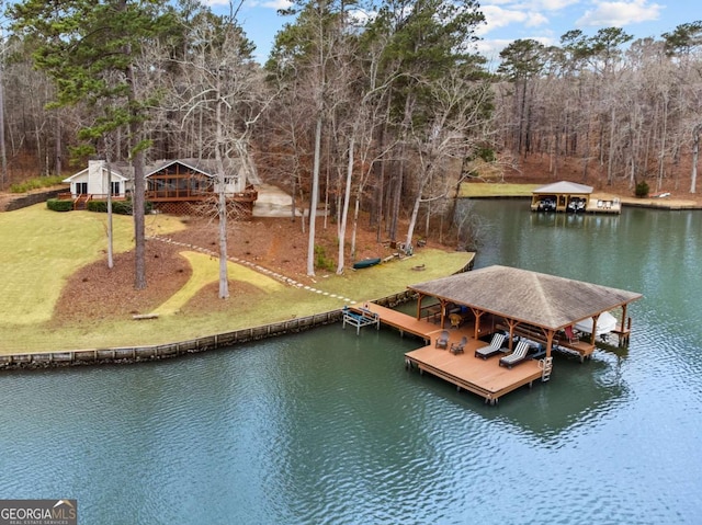 dock area featuring a water view and a lawn