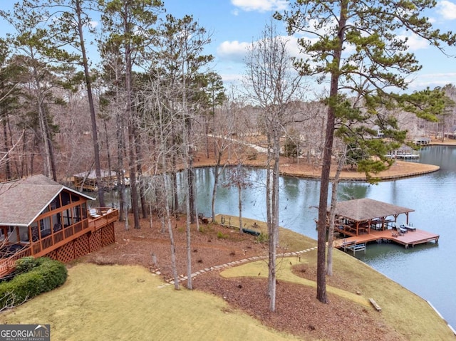 view of yard featuring a water view and a dock