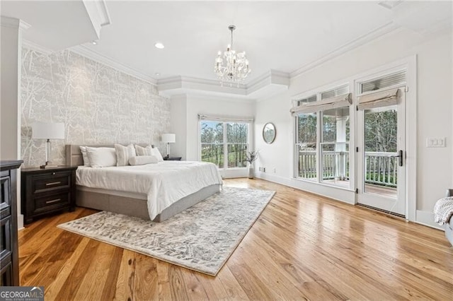 bedroom with access to exterior, crown molding, and light hardwood / wood-style floors