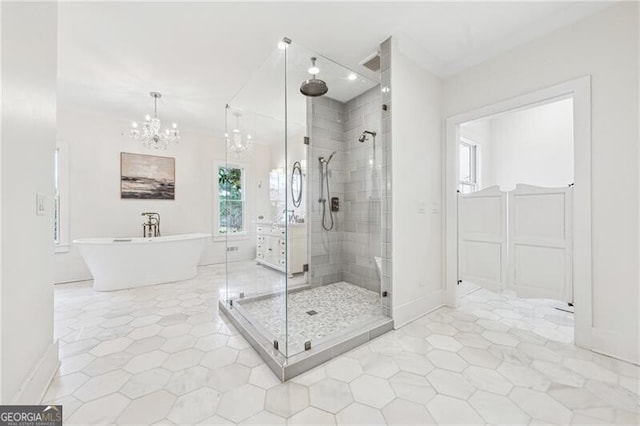 bathroom featuring an inviting chandelier, tile patterned floors, ornamental molding, and separate shower and tub