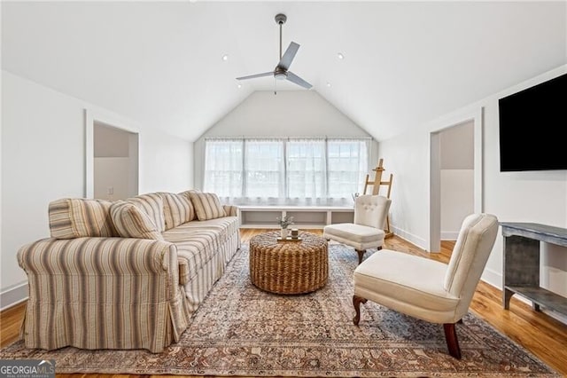 living room with vaulted ceiling, hardwood / wood-style floors, and ceiling fan