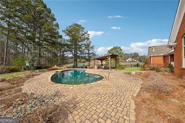 view of swimming pool featuring a gazebo and a patio