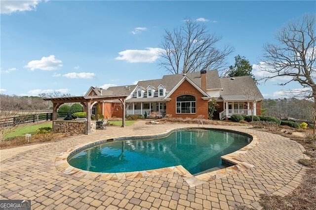 view of pool featuring a patio area and a pergola