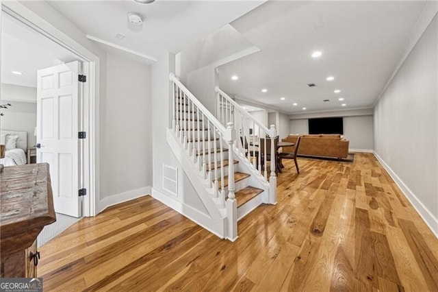 staircase featuring hardwood / wood-style floors