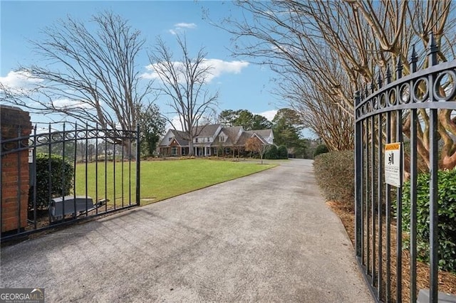 view of gate featuring a yard