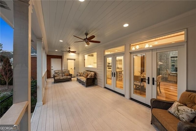 wooden deck featuring french doors, ceiling fan, and outdoor lounge area