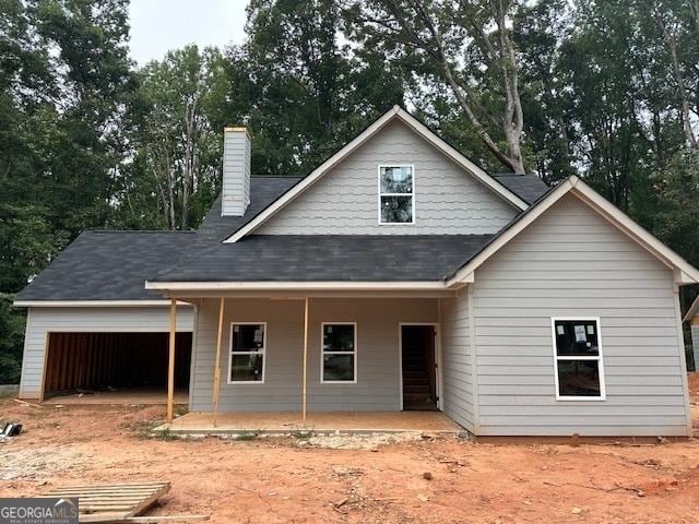 view of front of property with a garage and covered porch