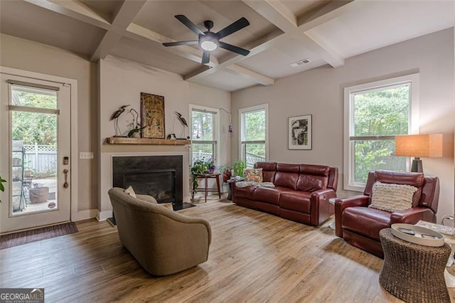 3157 Oakdale Rd, Hapeville, GA 30354 - living room featuring coffered ceiling, wood finished floors, plenty of natural light, a fireplace with flush hearth, and a ceiling fan