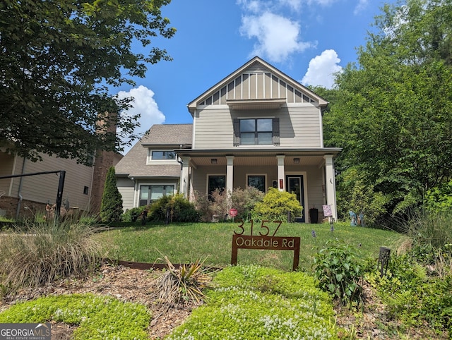 3157 Oakdale Rd, Hapeville, GA 30354 - craftsman house featuring a front yard, covered porch, and board and batten siding