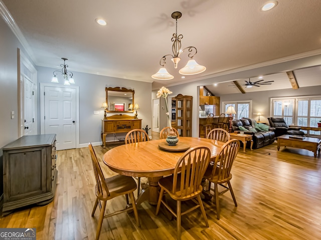 dining area with ceiling fan with notable chandelier, ornamental molding, light hardwood / wood-style floors, and lofted ceiling