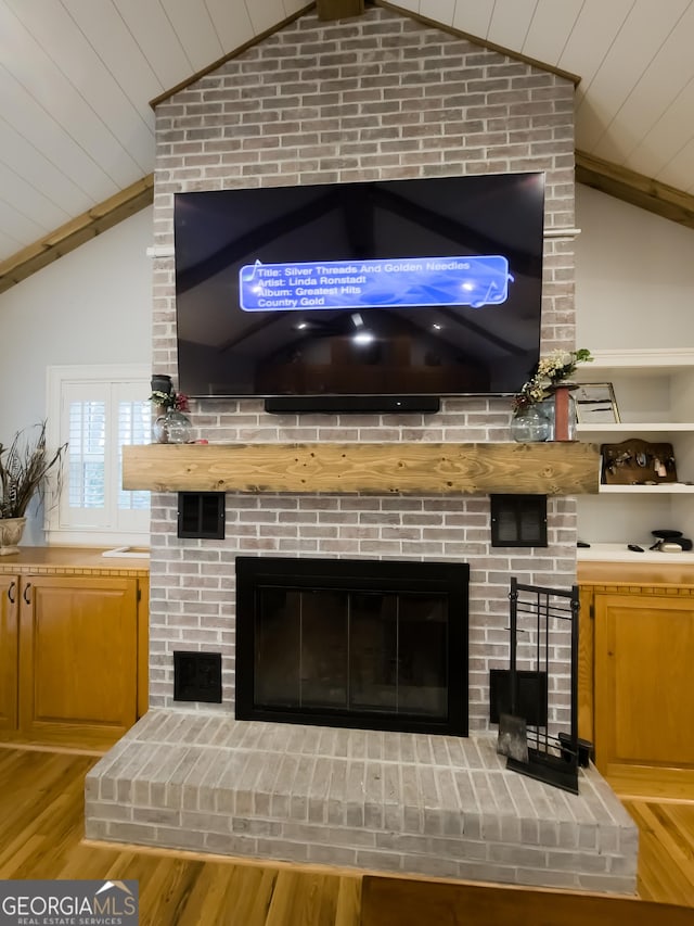 details featuring a brick fireplace, wooden ceiling, and wood-type flooring