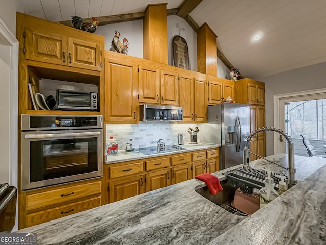 kitchen with appliances with stainless steel finishes, vaulted ceiling with beams, light stone counters, decorative backsplash, and wooden ceiling