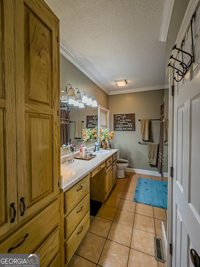 bathroom featuring a textured ceiling, vanity, tile patterned flooring, and crown molding