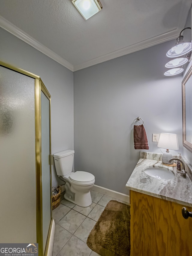 bathroom featuring tile patterned floors, vanity, crown molding, and a shower with door