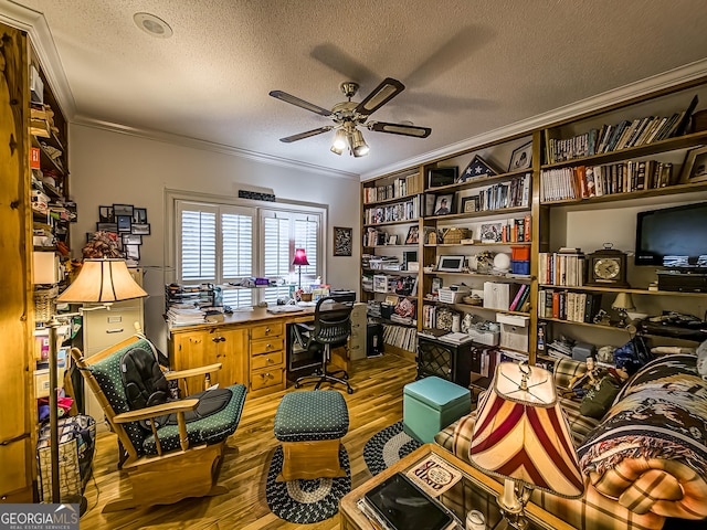 home office with ceiling fan, hardwood / wood-style flooring, a textured ceiling, and ornamental molding